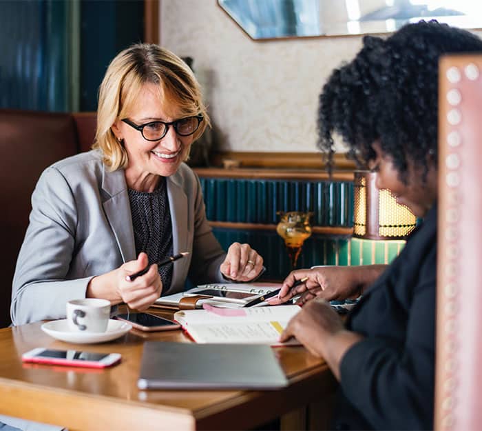 Two women work at a lunch booth